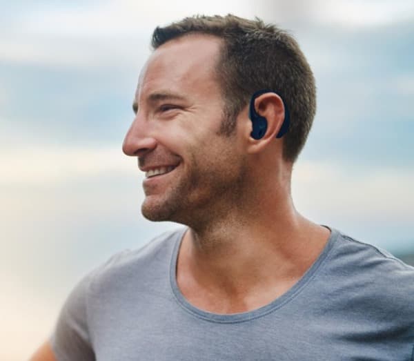 Person wearing an ear-mounted device